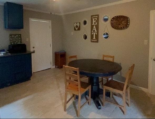 dining space with ornamental molding