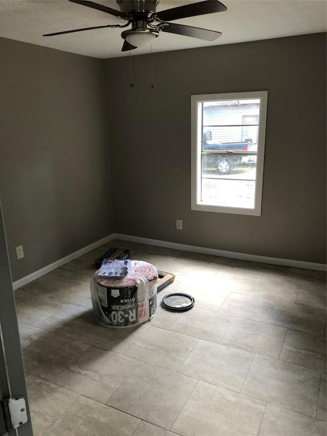 tiled empty room with ceiling fan