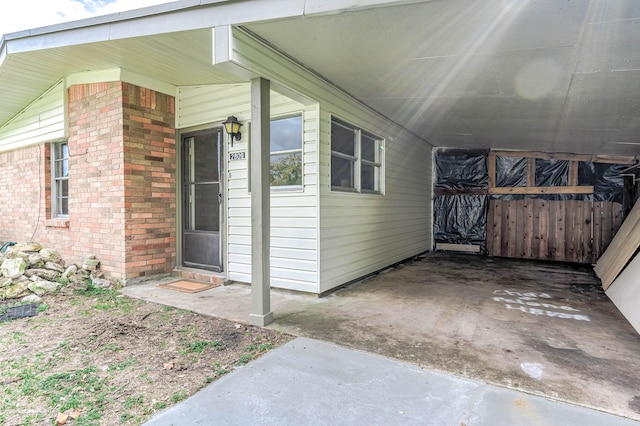 doorway to property featuring a carport