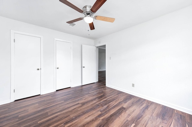 unfurnished bedroom with dark hardwood / wood-style flooring and ceiling fan