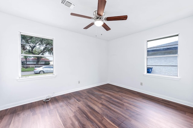 spare room featuring dark hardwood / wood-style floors and ceiling fan