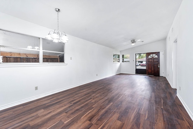 interior space with ceiling fan with notable chandelier, dark wood-type flooring, and vaulted ceiling