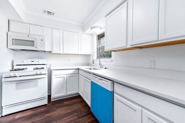 kitchen with white appliances, crown molding, sink, dark hardwood / wood-style flooring, and white cabinetry