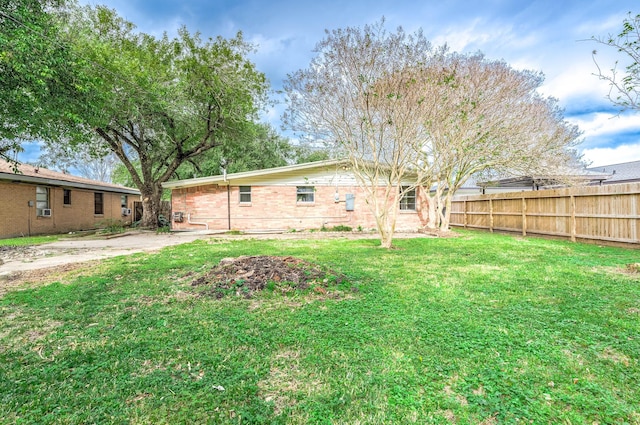 rear view of property featuring a yard