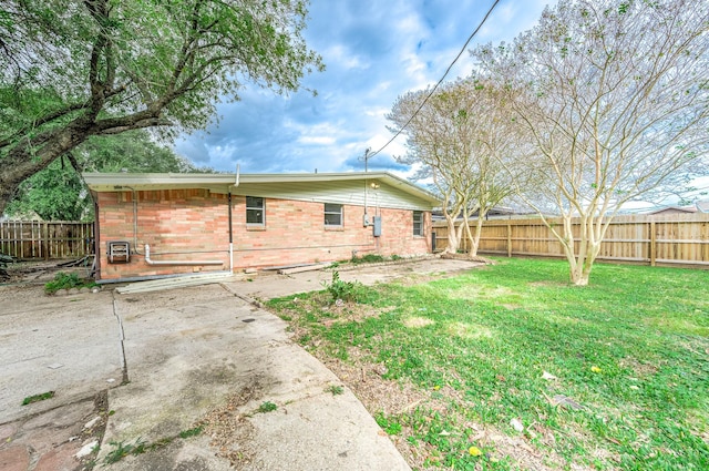 back of property featuring a yard and a patio