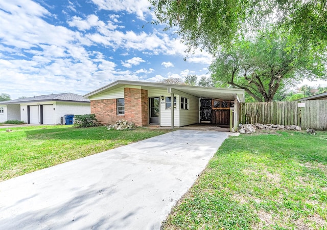 ranch-style home featuring a front lawn and a carport