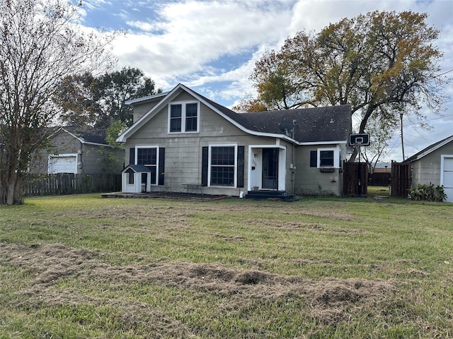 back of house featuring a yard and a storage unit