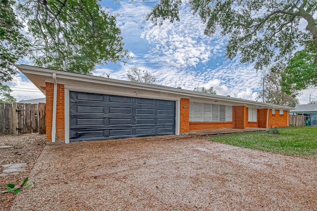 ranch-style home featuring a garage