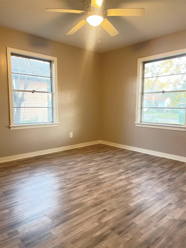 empty room featuring ceiling fan and dark wood-type flooring