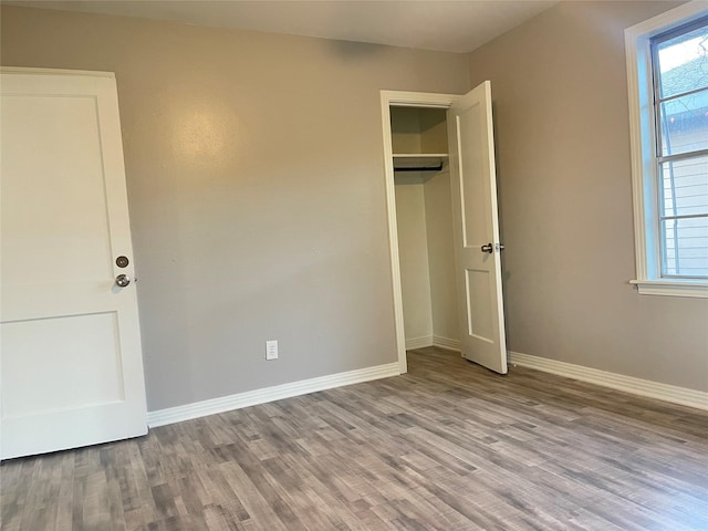 unfurnished bedroom with a closet and light hardwood / wood-style flooring