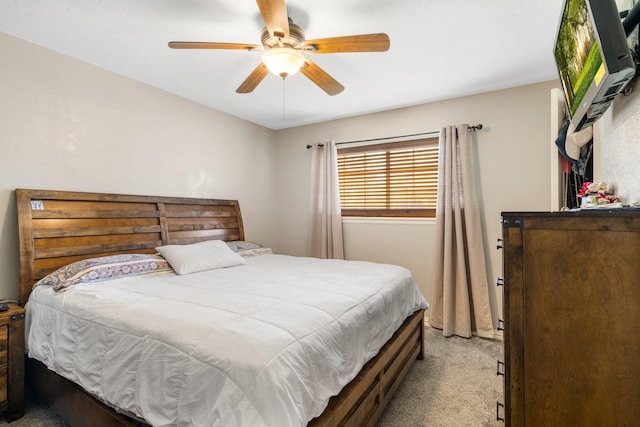 bedroom with ceiling fan and light carpet