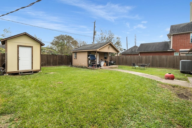 view of yard featuring central AC and a storage unit