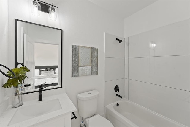 full bathroom with vanity, tiled shower / bath combo, and toilet