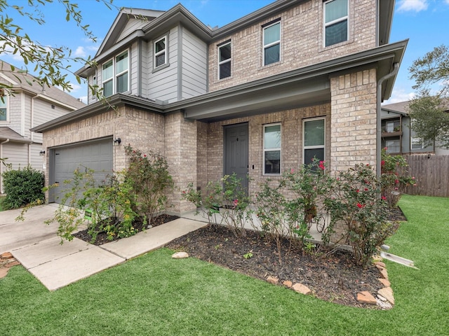 view of front of property featuring a front yard and a garage