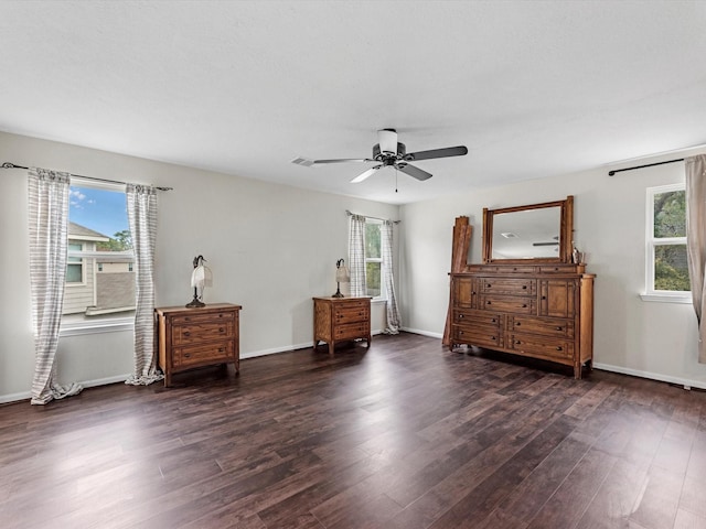 bedroom with dark hardwood / wood-style floors and ceiling fan