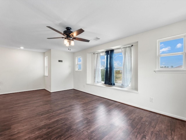 spare room featuring dark hardwood / wood-style floors and ceiling fan