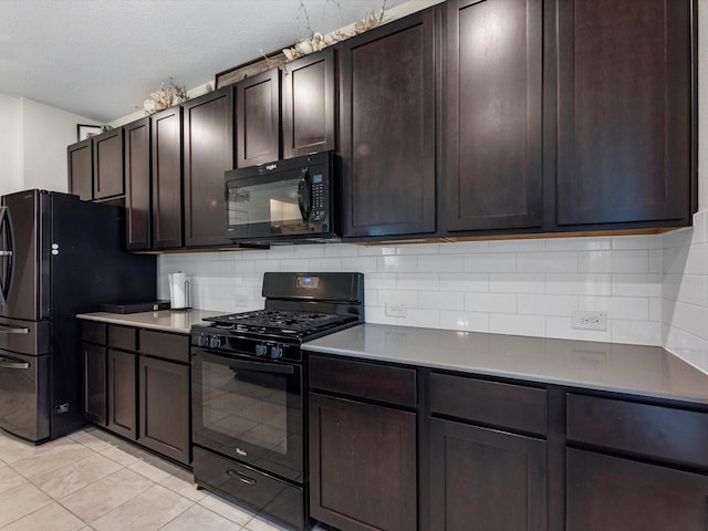 kitchen with a textured ceiling, decorative backsplash, dark brown cabinets, light tile patterned flooring, and black appliances