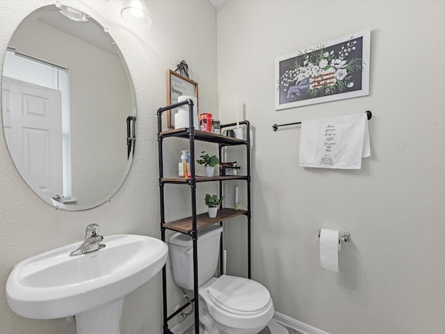 bathroom featuring sink and toilet