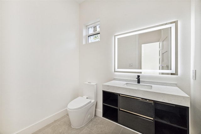 bathroom featuring toilet, vanity, and tile patterned floors