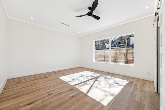 empty room with ceiling fan, ornamental molding, and light hardwood / wood-style flooring