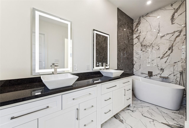 bathroom with vanity, a bathtub, and tile walls