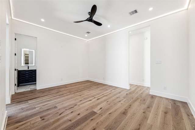 empty room with ceiling fan and light hardwood / wood-style floors