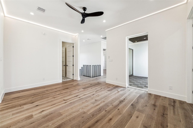 spare room with ceiling fan and light hardwood / wood-style flooring