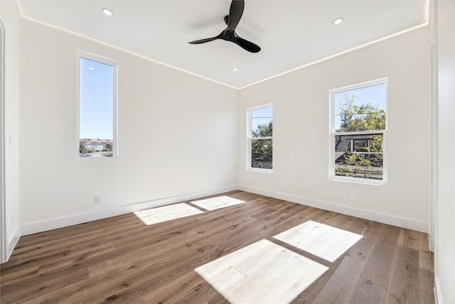 empty room featuring ceiling fan and hardwood / wood-style flooring