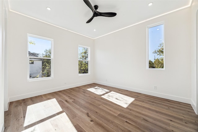 unfurnished room with ceiling fan and wood-type flooring