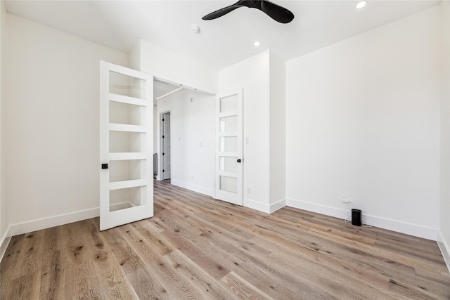 empty room featuring light wood-type flooring and ceiling fan