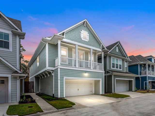 view of front of property featuring a balcony and a garage