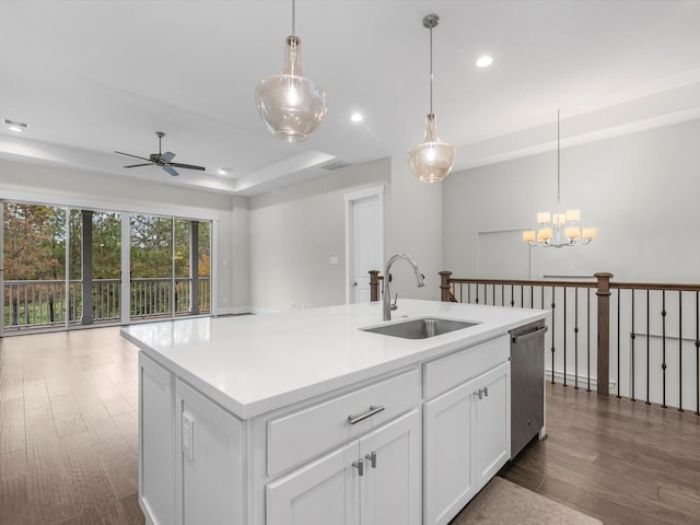 kitchen with white cabinets, ceiling fan with notable chandelier, a kitchen island with sink, sink, and dishwasher