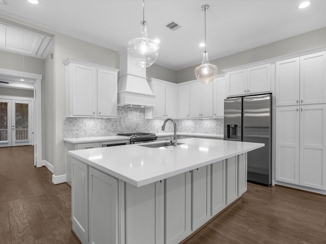 kitchen featuring white cabinetry, sink, dark hardwood / wood-style flooring, decorative backsplash, and appliances with stainless steel finishes