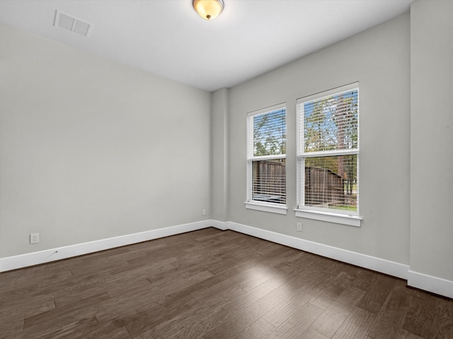 unfurnished room featuring dark wood-type flooring