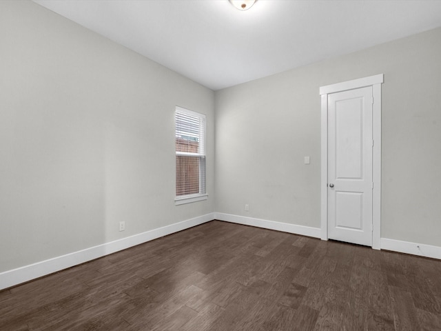 empty room featuring dark wood-type flooring