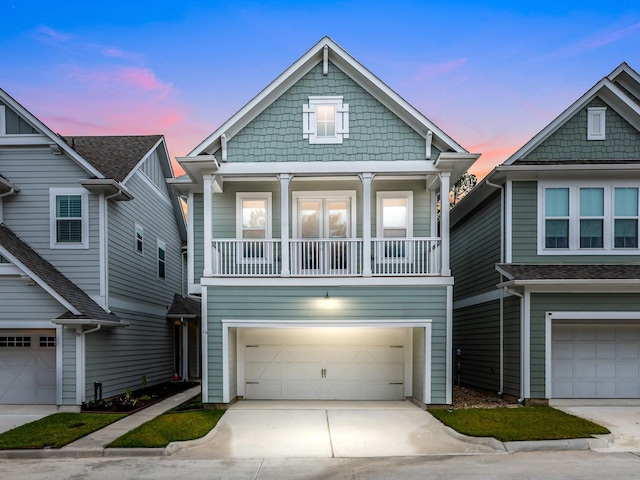 view of front of home featuring a balcony and a garage