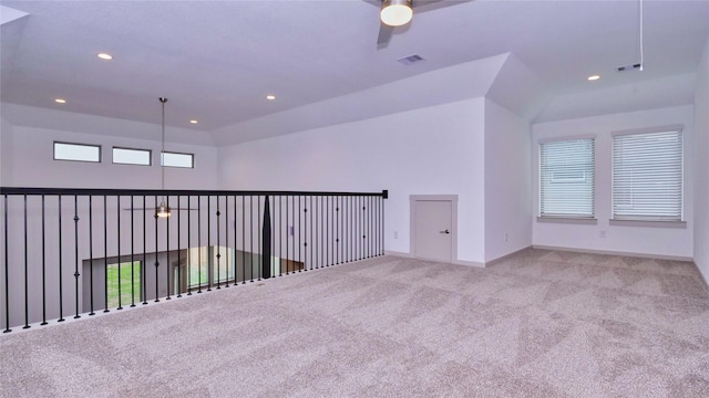 carpeted spare room featuring ceiling fan and lofted ceiling