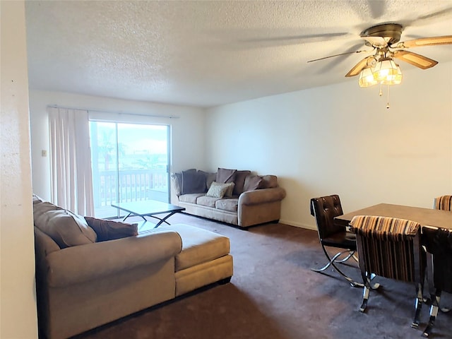 living room featuring carpet, ceiling fan, and a textured ceiling