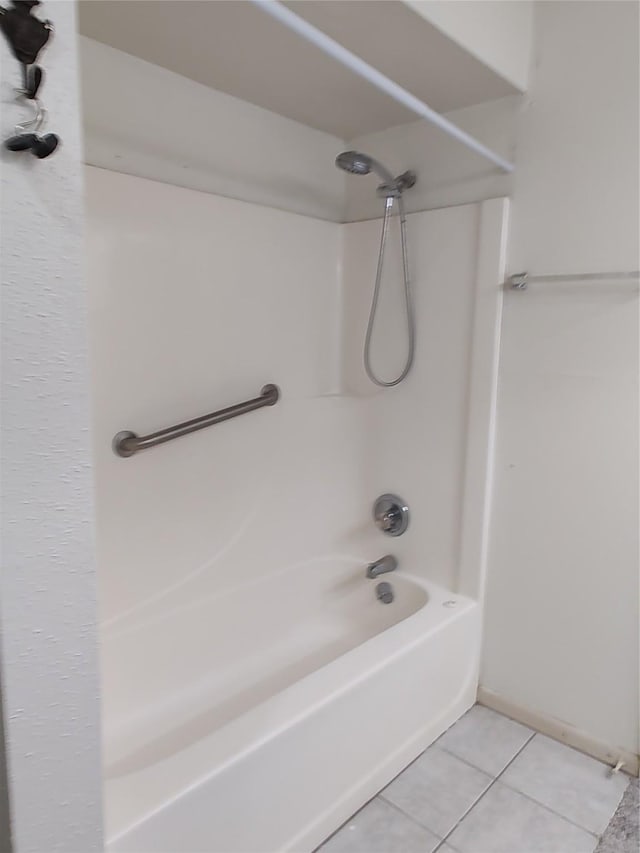 bathroom with tile patterned floors and washtub / shower combination