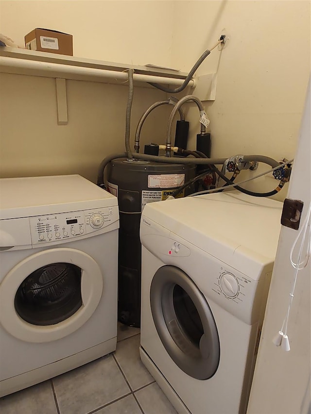 washroom featuring washing machine and clothes dryer and light tile patterned flooring