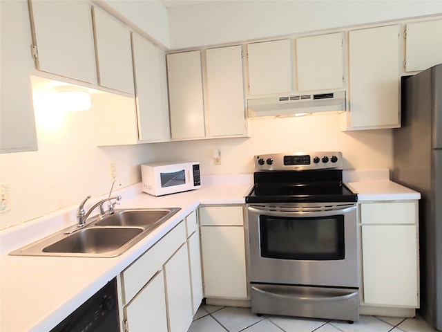 kitchen featuring white cabinetry, sink, light tile patterned floors, and stainless steel appliances