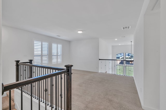 hallway featuring light carpet