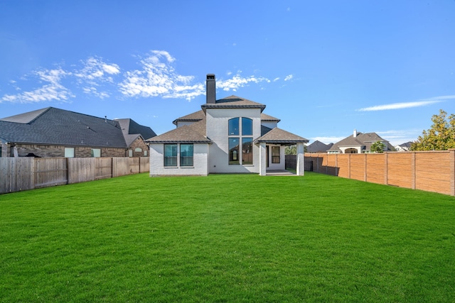 back of property featuring a lawn