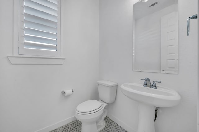 bathroom featuring toilet and tile patterned flooring