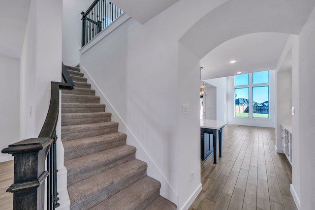 stairway with hardwood / wood-style flooring