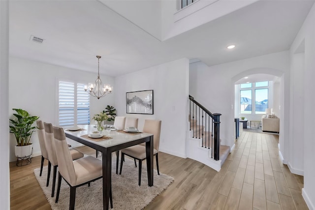 dining space with a chandelier and light wood-type flooring