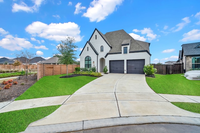 french country inspired facade with a front lawn and a garage