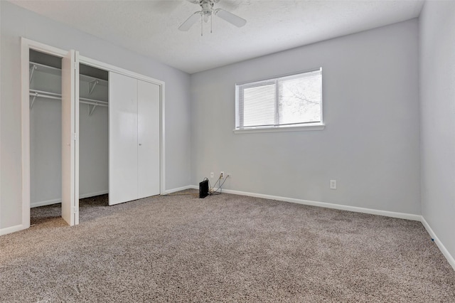 unfurnished bedroom with a ceiling fan, carpet, baseboards, and a textured ceiling