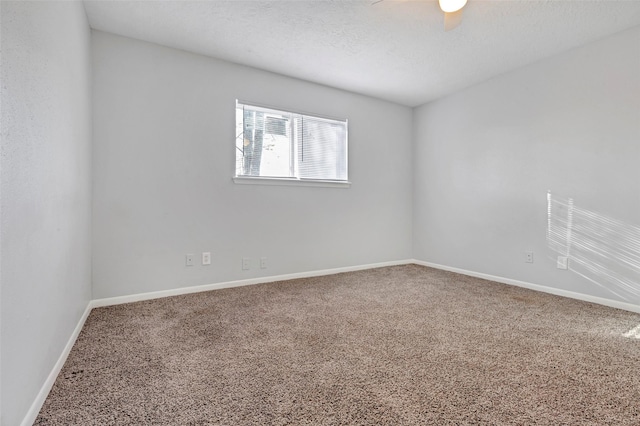 unfurnished room featuring ceiling fan, carpet, and a textured ceiling