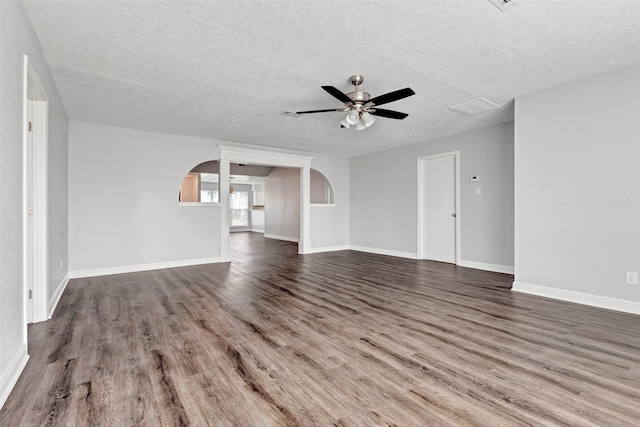 unfurnished living room with dark hardwood / wood-style flooring, a textured ceiling, and ceiling fan